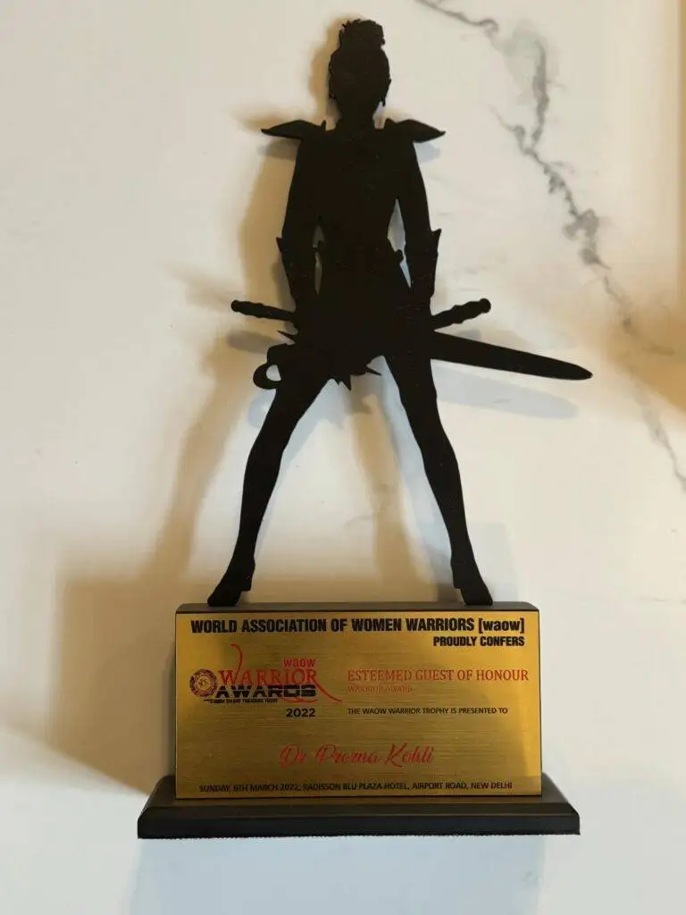 Dr. Prerna Kohli WAOW Warrior Award trophy 2022 as Esteemed Guest of Honour — World Association of Women Warriors Radisson Blu New Delhi March 2022 — Clinical Psychologist India