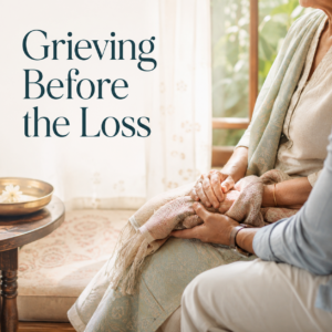 An adult child gently holding the hands of an ageing parent, representing anticipatory grief, caregiving and emotional support within Indian families.