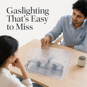 An Indian couple sits across a table as the man points to conflicting versions of the same image, symbolising how gaslighting distorts facts and causes a partner to doubt their memory. Insights by Dr. Prerna Kohli, Psychologist and Relationship Expert.